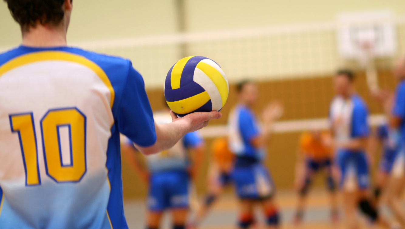 man holding volleyball