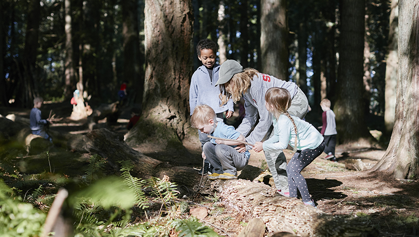 children and adult in woods