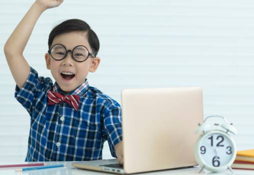 child in front of laptop